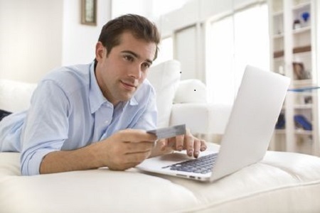 Man using credit card and laptop, shopping online